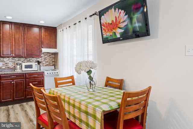 dining space with light hardwood / wood-style flooring