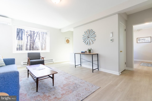 living room with a wall mounted air conditioner, a baseboard heating unit, and light wood-type flooring