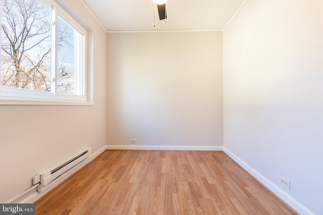 spare room with crown molding, a baseboard radiator, ceiling fan, and light hardwood / wood-style flooring