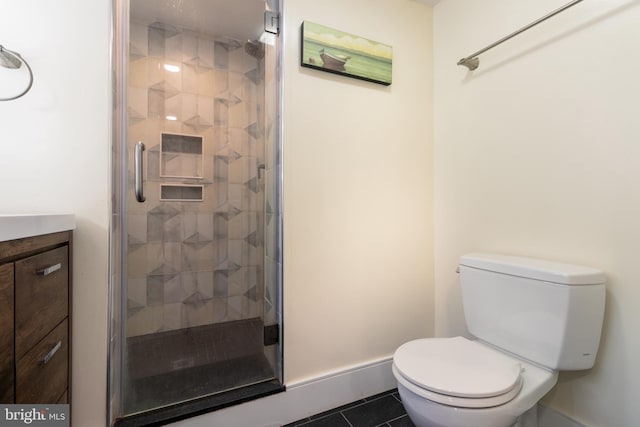 bathroom featuring vanity, an enclosed shower, tile patterned floors, and toilet