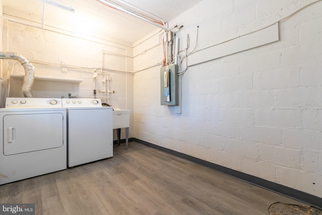 laundry area featuring hardwood / wood-style flooring, electric panel, and independent washer and dryer