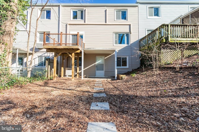 rear view of property featuring a deck