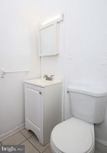 bathroom featuring tile patterned floors, toilet, and vanity