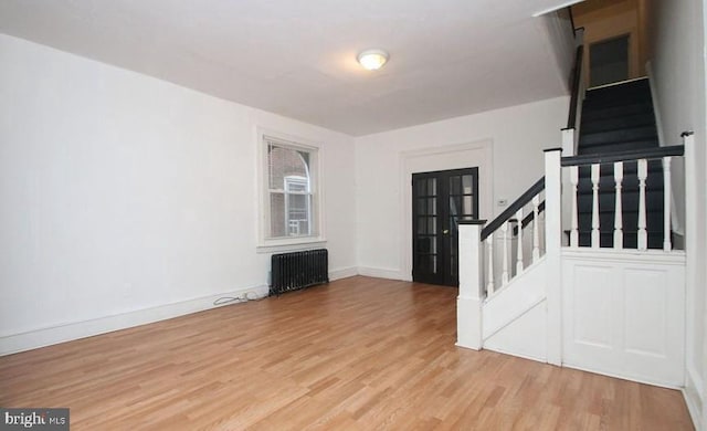 interior space with radiator heating unit and light wood-type flooring