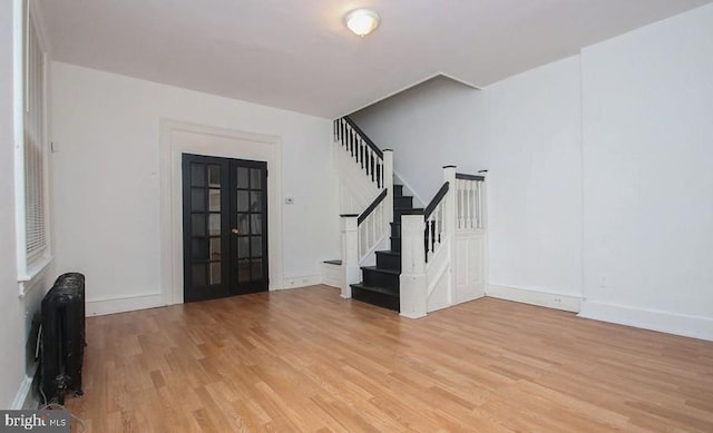 entryway featuring french doors and light hardwood / wood-style floors