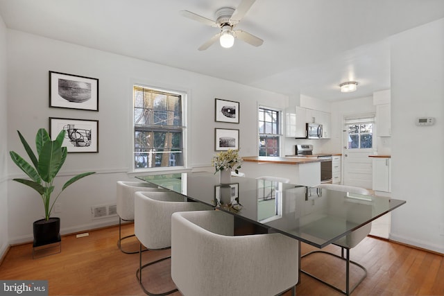 dining room featuring light hardwood / wood-style flooring and ceiling fan