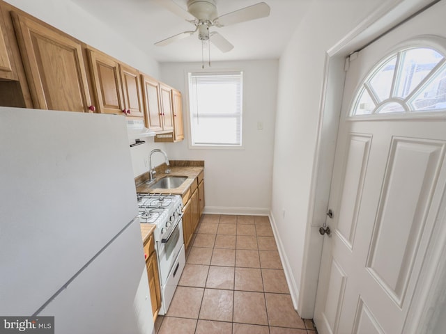 kitchen with ceiling fan, sink, light tile patterned floors, and white appliances