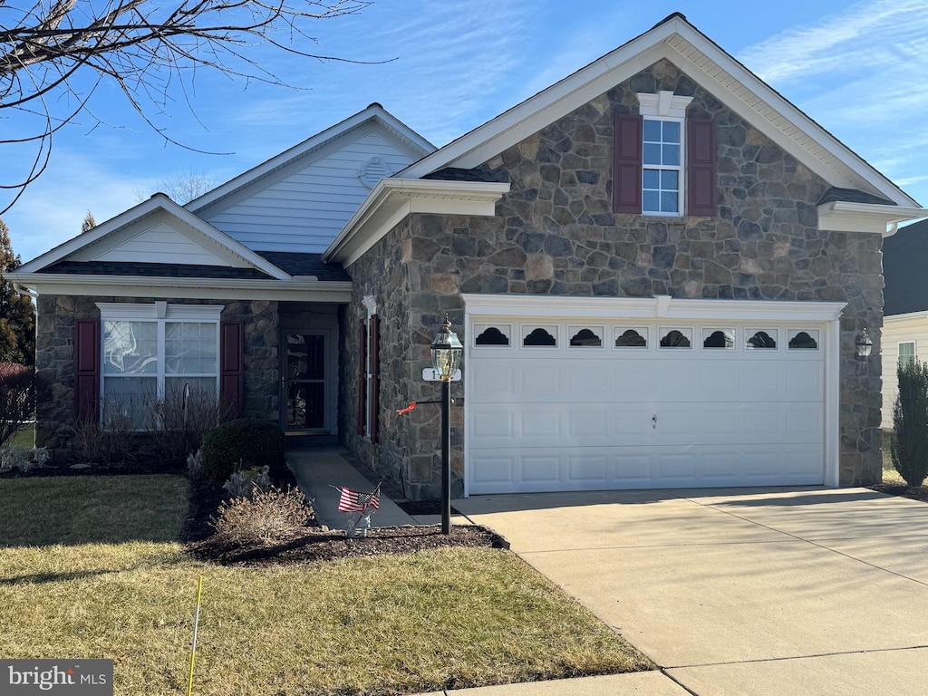 view of front of home with a garage and a front yard