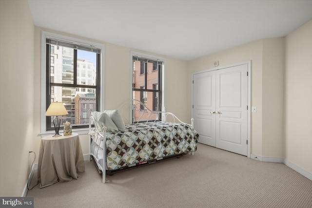 carpeted bedroom featuring a closet