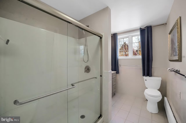 bathroom with walk in shower, a baseboard radiator, toilet, and tile walls