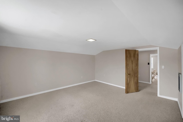 additional living space with lofted ceiling and carpet