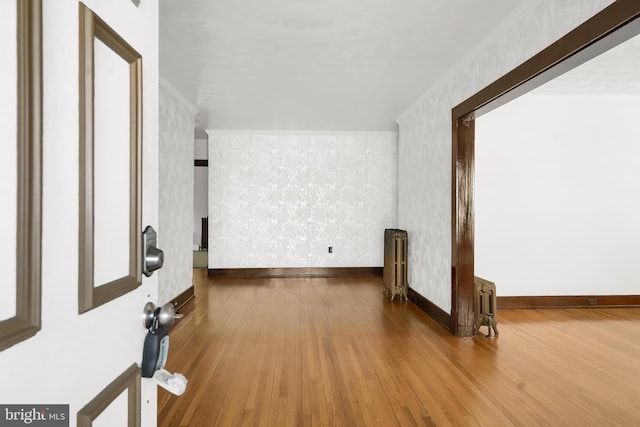 interior space with radiator heating unit and wood-type flooring