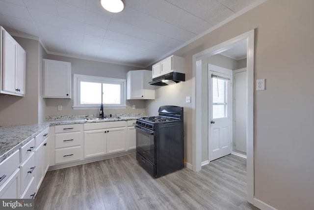 kitchen featuring white cabinetry, light stone counters, black range with gas stovetop, and plenty of natural light