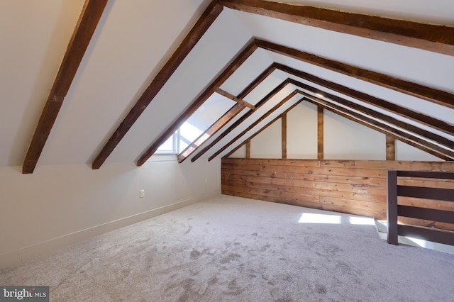 bonus room featuring lofted ceiling with skylight and carpet