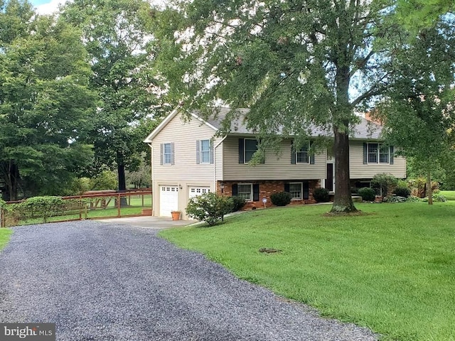 raised ranch with a garage and a front yard