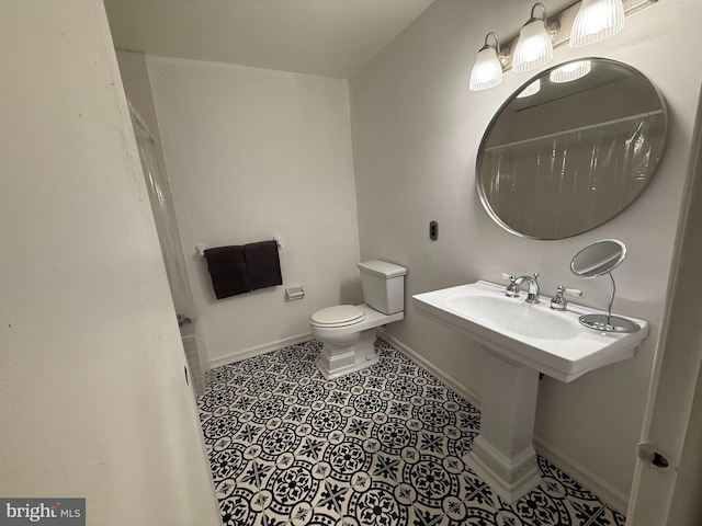 bathroom featuring sink, tile patterned floors, and toilet