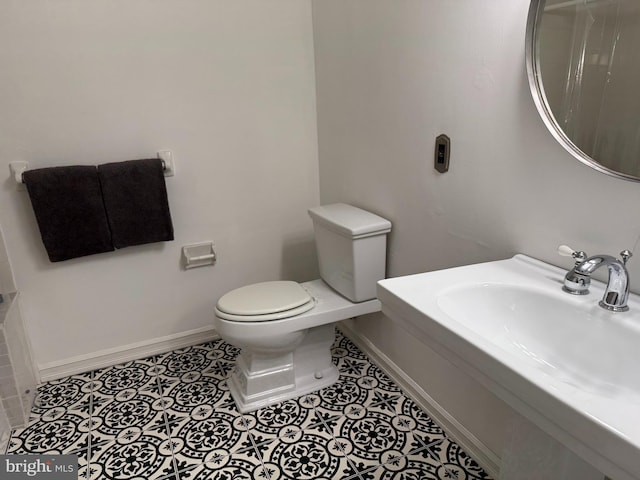 bathroom featuring tile patterned flooring, sink, and toilet