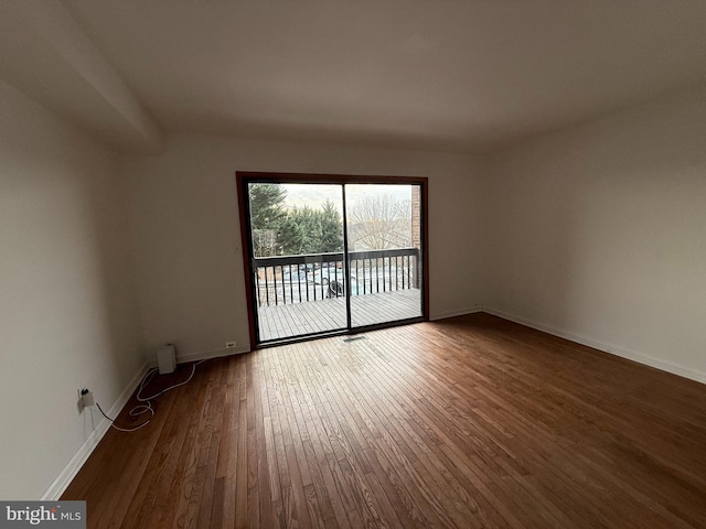 spare room featuring dark hardwood / wood-style flooring