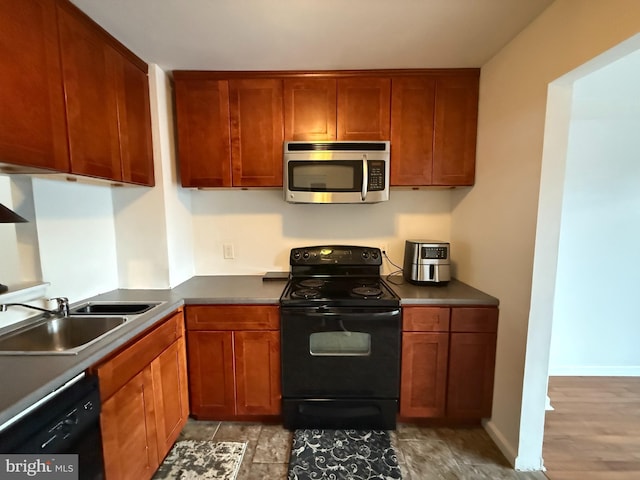 kitchen featuring sink and black appliances