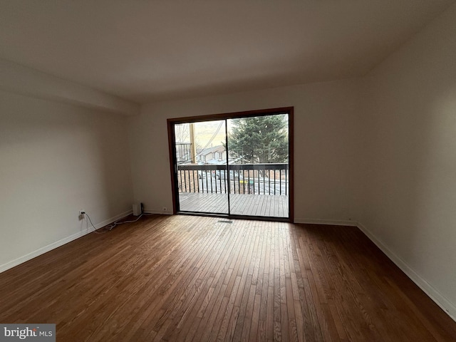 empty room with dark hardwood / wood-style floors