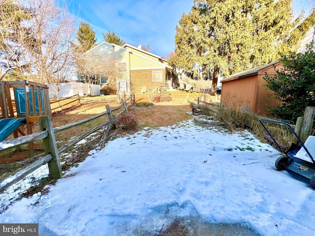 view of yard layered in snow