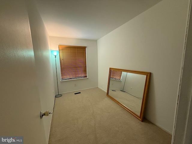 empty room with light colored carpet