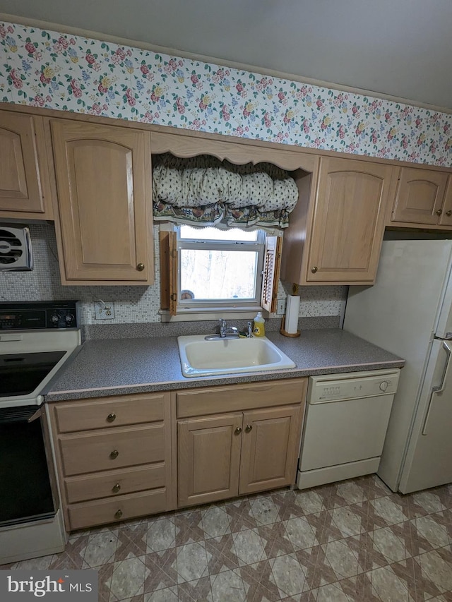 kitchen featuring white appliances and sink