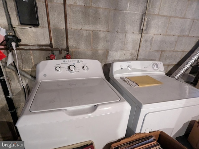 clothes washing area with washer and dryer