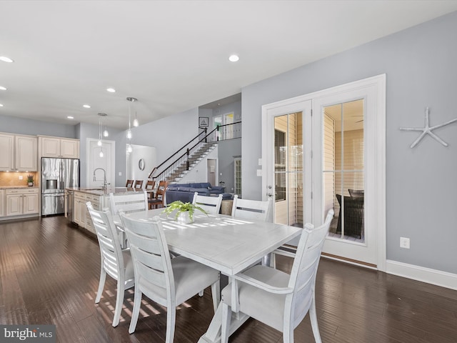 dining space with dark wood-type flooring and sink