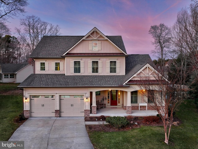 craftsman-style home featuring a yard, a garage, and a porch