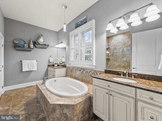 bathroom featuring vanity and independent shower and bath