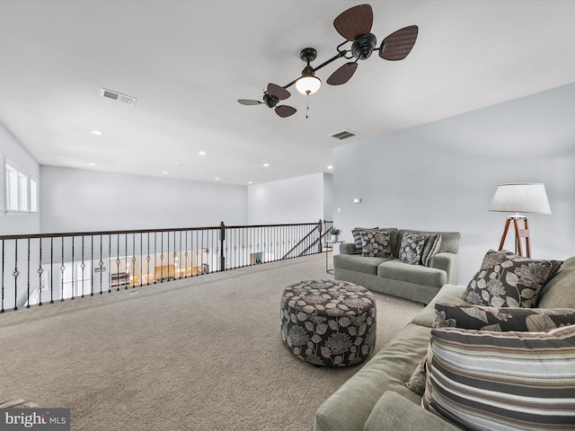 carpeted living room with ceiling fan