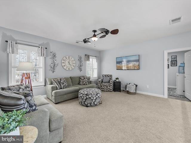 carpeted living room with a healthy amount of sunlight and ceiling fan