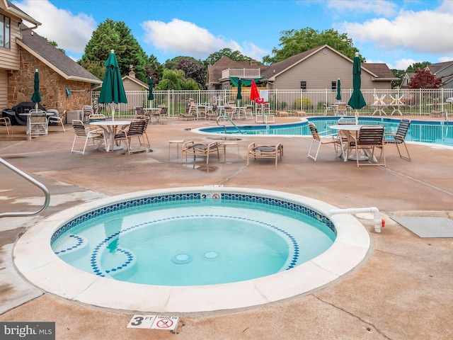 view of pool featuring a community hot tub and a patio