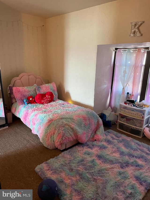 bedroom featuring multiple windows and carpet