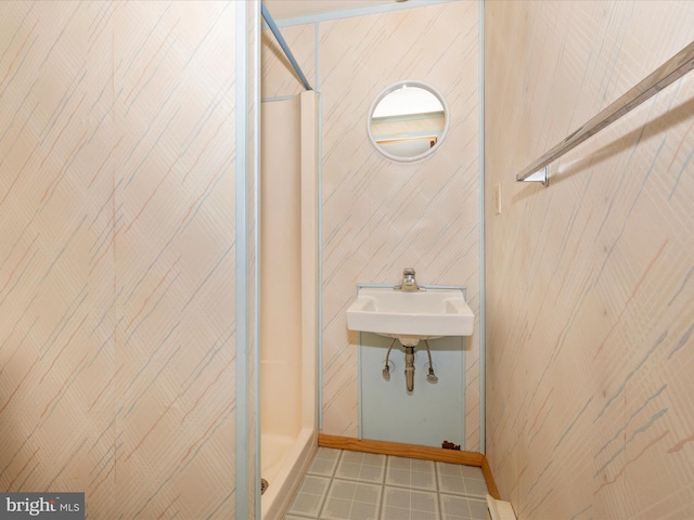 full bathroom featuring a sink and a shower stall