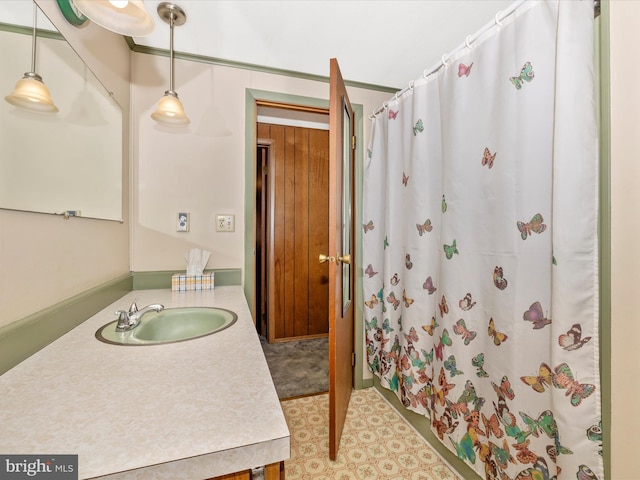 bathroom featuring curtained shower, vanity, and tile patterned floors