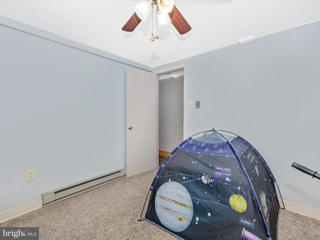 carpeted bedroom featuring a baseboard radiator and a ceiling fan