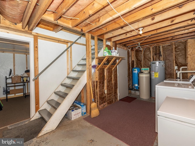 unfinished below grade area with electric water heater, independent washer and dryer, and stairs