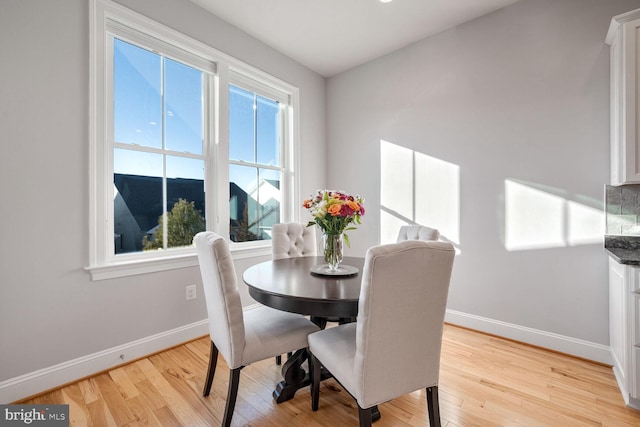 dining room featuring plenty of natural light and light hardwood / wood-style flooring