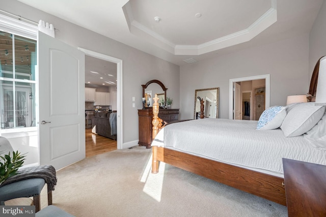 carpeted bedroom featuring a raised ceiling and crown molding