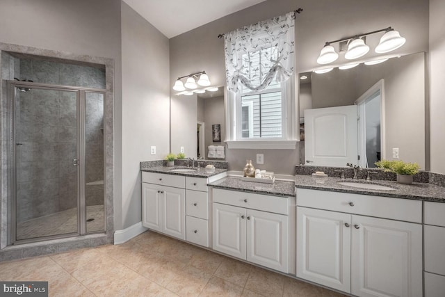 bathroom featuring vanity, tile patterned floors, and a shower with shower door