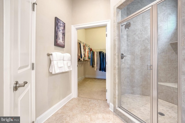 bathroom with tile patterned flooring and a shower with door