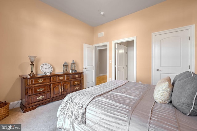 bedroom featuring light carpet