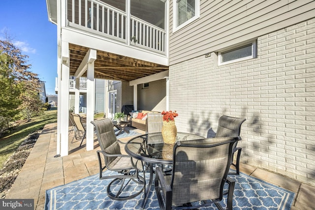 view of patio featuring a balcony and an outdoor living space