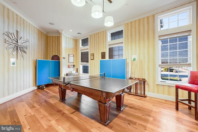 rec room featuring radiator heating unit, ornamental molding, and light hardwood / wood-style floors