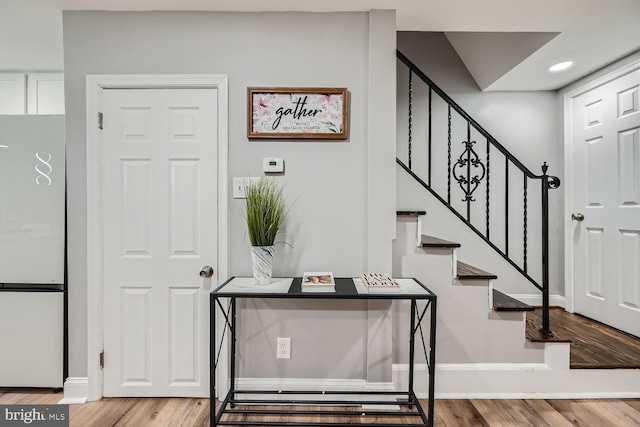 entryway with hardwood / wood-style flooring