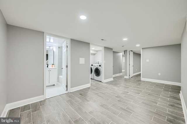 laundry room featuring separate washer and dryer and light wood-type flooring