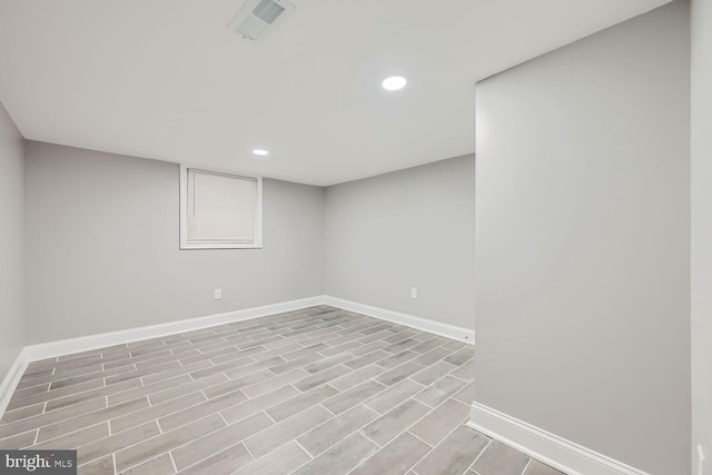 basement with light hardwood / wood-style flooring