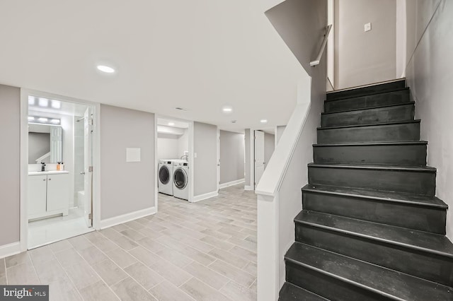 stairs featuring sink and independent washer and dryer